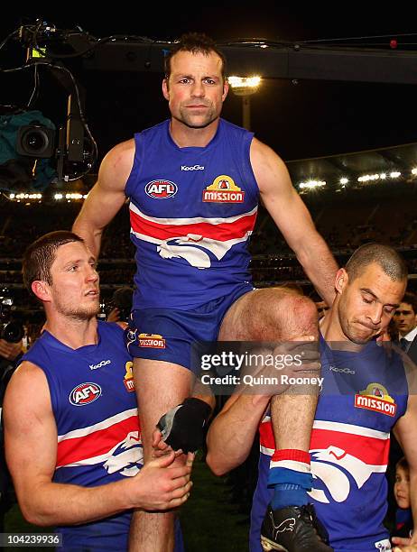 Brad Johnson of the Bulldogs is carried from the ground after playing his final game during the Seecond AFL Preliminary Final match between the St...