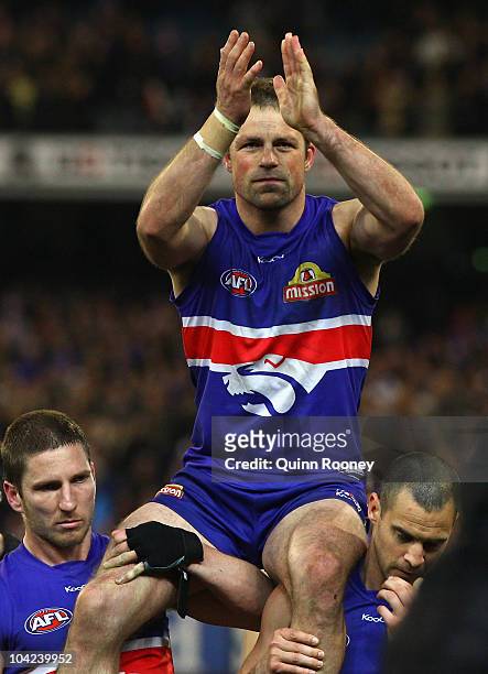 Brad Johnson of the Bulldogs is carried from the ground after playing his final game during the Seecond AFL Preliminary Final match between the St...