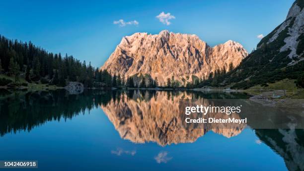 mountain peak zugspitze reflection in lake seebensee - wetterstein mountains stock pictures, royalty-free photos & images