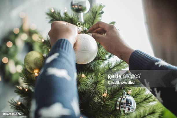 decorating christmas tree - decoration stock pictures, royalty-free photos & images