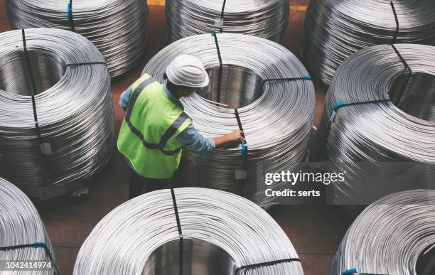 young engineer man checking production line in wire warehouse - spool stock pictures, royalty-free photos & images