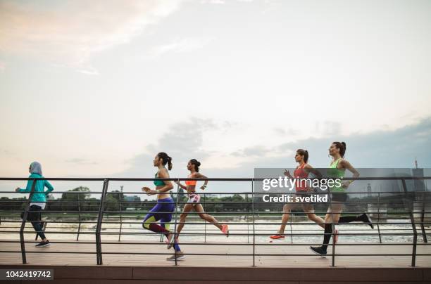 team jogging - woman marathon stock pictures, royalty-free photos & images