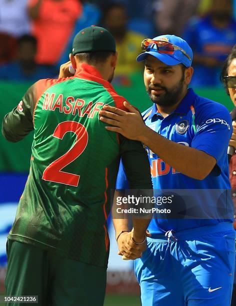 Indian cricket captain Rohit Sharma shakes hand with Bangladesh cricket captain Mashrafe Mortaza during the final cricket match of Asia Cup 2018...