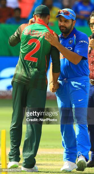 Indian cricket captain Rohit Sharma shakes hand with Bangladesh cricket captain Mashrafe Mortaza during the final cricket match of Asia Cup 2018...
