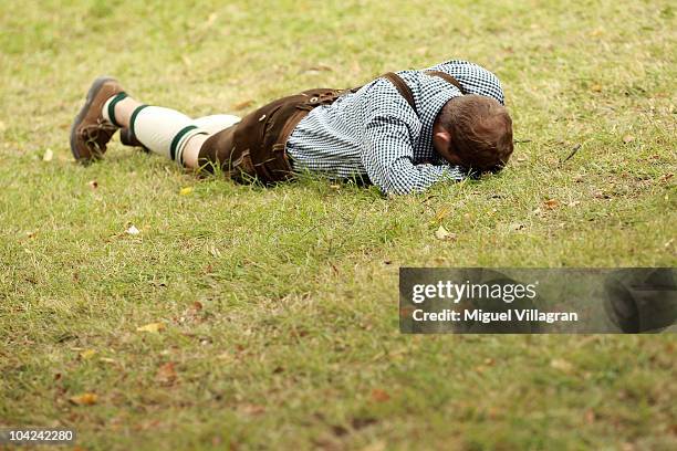 Drunk man sleeps on a meadow during the opening day of the Oktoberfest at Theresienwiese on September 18, 2010 in Munich, Germany. 2010 marks the...