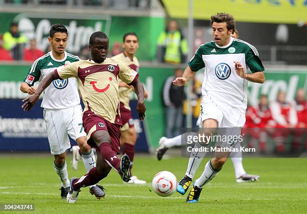 Didier Ya Konan of Hannover battles for the ball with Andrea Barzagli of Wolfsburg during the Bundesliga match between VFL Wolfsburg and Hannover 96...