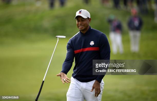 Golfer Tiger Woods juggles his putter during his fourball match on the first day of the 42nd Ryder Cup at Le Golf National Course at...
