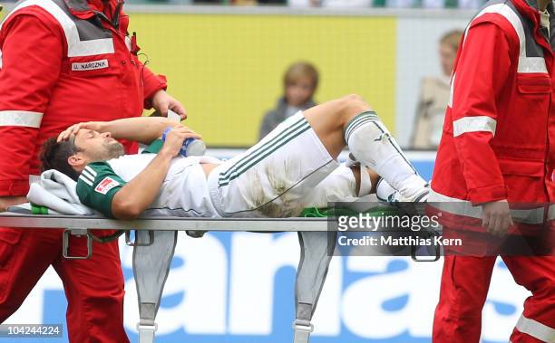 Diego Ribas da Cunha is injured during the Bundesliga match between VFL Wolfsburg and Hannover 96 at Volkswagen Arena on September 18, 2010 in...