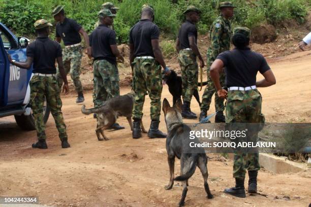 Military police arrive on Katampe Hills, on the outskirts of Abuja, where two Nigerian Air Force fighter jets taking part in rehearsals ahead of the...