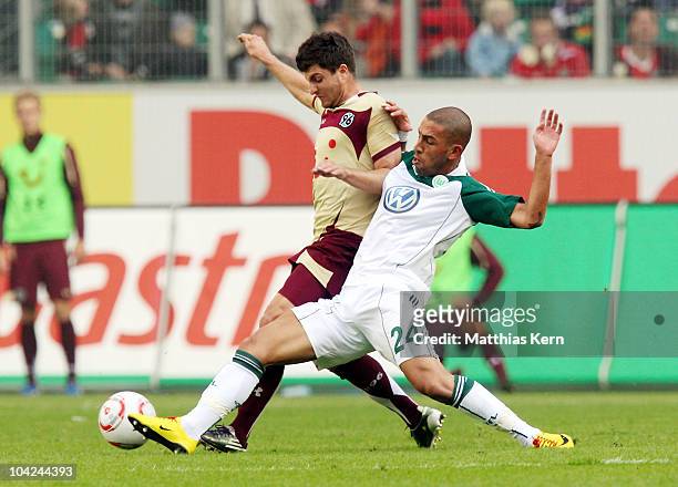 Moritz Stoppelkamp of Hannover battles for the ball with Ashkan Dejagah of Wolfsburg during the Bundesliga match between VFL Wolfsburg and Hannover...