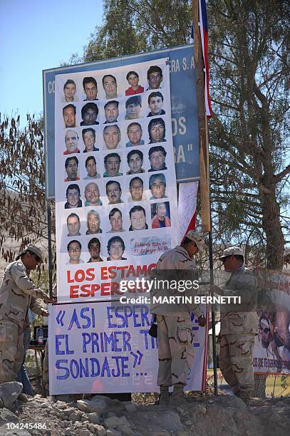 Chilean soldiers prepare a ceremony during which a national flag signed by the 33 miners trapped inside the mine will be raised, at San Jose mine,...