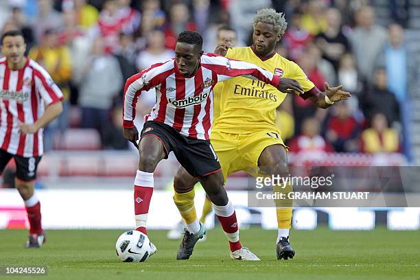 Sunderland's English striker Danny Welbeck vies with Arsenal's Cameroonian midfielder Alex Song during the English Premier League football match...