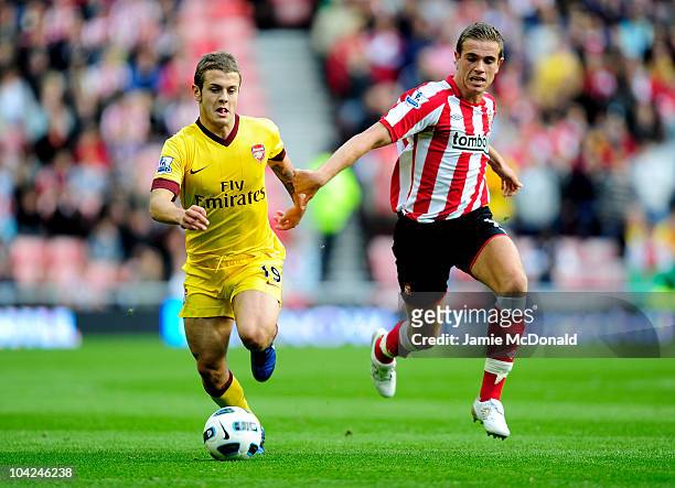 Jordan Henderson of Sunderland challenges Jack Wilshere of Arsenal during the Barclays Premier League match between Sunderland and Arsenal at the...