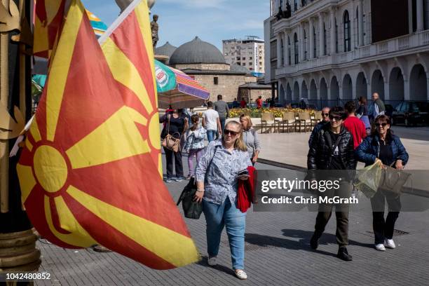 People walk past a shop selling Macedonian flags on September 28, 2018 in Skopje, Macedonia. Macedonians will go to the polls Sunday to vote in a...