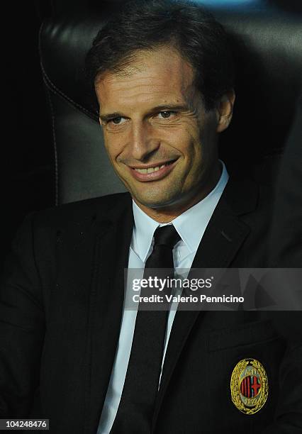 Milan head coach Massimiliano Allegri sits on the bench during the Serie A match between AC Milan and Catania Calcio at Stadio Giuseppe Meazza on...