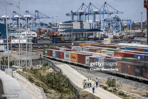 Shipping containers sit beside railway lines running into Mombasa port, operated by Kenya Ports Authority, in Mombasa, Kenya, on Saturday, Sept. 1,...