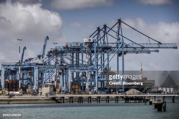 Ship-to-shore cranes loads containers onto a ship at Mombasa port, operated by Kenya Ports Authority, in Mombasa, Kenya, on Saturday, Sept. 1, 2018....