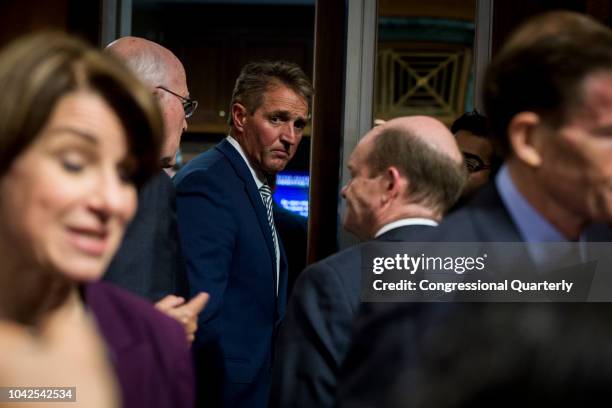 Sen. Jeff Flake, R-Ariz., exits the Senate Judiciary Committee meeting about the Supreme Court nominee Brett Kavanaugh Friday Sept. 28, 2018.