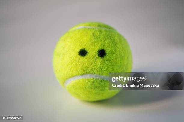 anthropomorphic object. tennis ball - missed train stockfoto's en -beelden