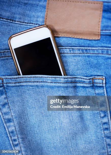 cell phone in back pocket - hosentasche stock-fotos und bilder
