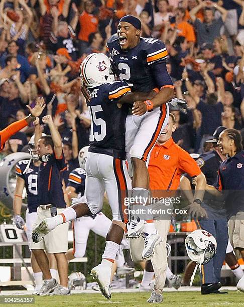 Quarterback Cameron Newton and Neiko Thorpe of the Auburn Tigers celebrate after their 27-24 overtime win over the Clemson Tigers at Jordan-Hare...