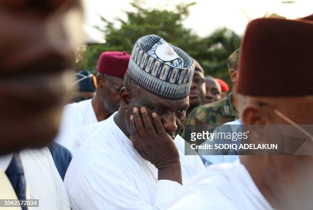 Relative reacts during the funerals of two Air Force pilots killed in a fighter jet crash in Abuja on September 28, 2018 during their funerals. -...