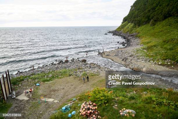 fishermen fishing for pink salmon at the sea of okhotsk in hokkaido, japan - shiretoko stock pictures, royalty-free photos & images