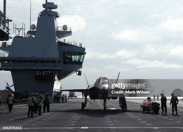 New F-35B Lightning fighter jet is prepped for take off from the deck of the United Kingdom's new aircraft carrier, The HMS Queen Elizabeth at sea in...