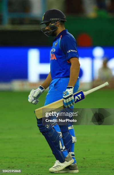 Indian cricket captain Rohit Sharma walks back following his dismissal during the final cricket match of Asia Cup 2018 between India and Bangladesh...