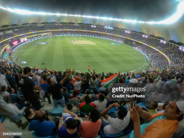 Indian cricket fans cheer during the final cricket match of Asia Cup 2018 between India and Bangladesh at Dubai International cricket stadium,Dubai,...