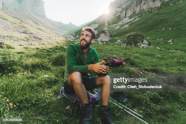 man hiking in swiss alps in appenzell - aventura imagens e fotografias de stock