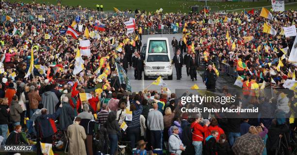 Pope Benedict XVI is surrounded by pilgrims as he arrives for the beatification mass of Cardinal Newman at Cofton Park on September 19, 2010 in...