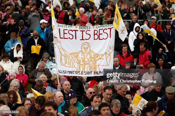 Pilgrims look on as Pope Benedict XVI takes the beatification mass of Cardinal Newman at Cofton Park on September 19, 2010 in Birmingham, England. On...