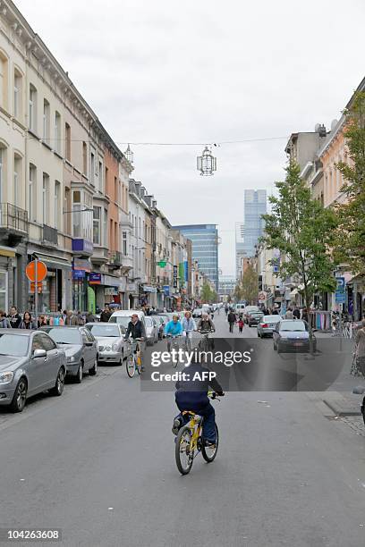 Cyclists ride along the Brabantstraat - Rue de Brabant, a street known for places to buy turkish specialities, in Brussels, during Car Free Sunday on...