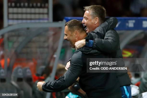 Berlin's Hungarian head coach Pal Dardai celebrates with his assistant coach Rainer Widmayer at the final whistle of the German first division...