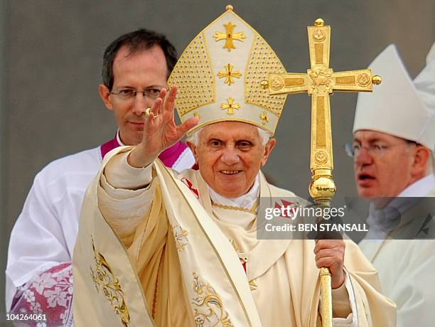 Pope Benedict XVI waves as he conducts a Mass to beatify Cardinal John Henry Newman in Cofton Park, in Birmingham, central England, on September 19,...