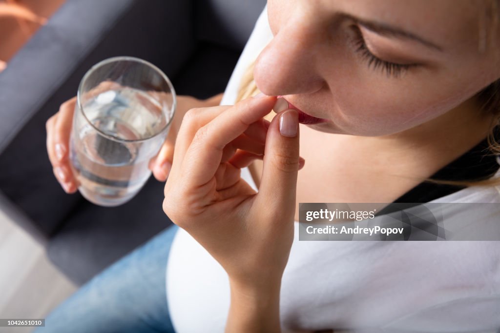 Pregnant Woman Taking Medicine