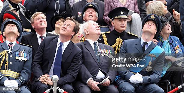 British Prime Minister David Cameron, Prince William and dignitaries watch a flyby during the National Commemorative Service for the 70th Anniversary...