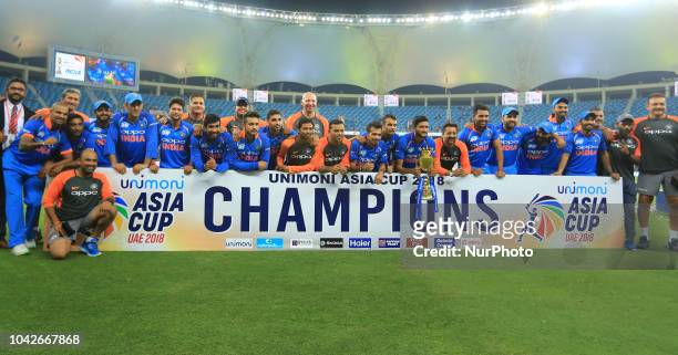 Indian cricket team pose for a photograph after winning the Asia Cup 2018 at Dubai International cricket stadium,Dubai, United Arab Emirates.