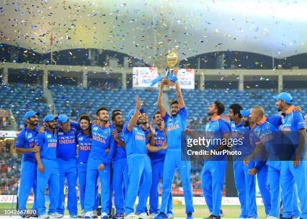 Indian cricket team pose with the Asia Cup 2018 at Dubai International cricket stadium,Dubai, United Arab Emirates.