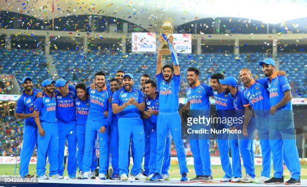 Indian cricket team pose with the Asia Cup 2018 after defeating Bangladesh in the final at Dubai International cricket stadium,Dubai, United Arab...