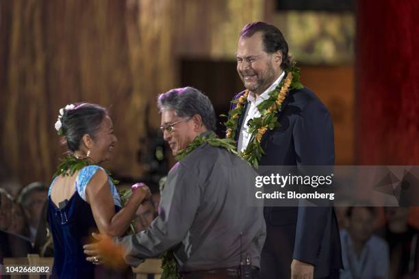 Marc Benioff, chairman and co-chief executive officer of Salesforce.com Inc., right, receives a Hawaiian lei at the beginning of the opening keynote...