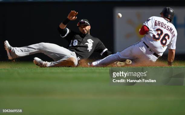 Robbie Grossman of the Minnesota Twins reaches second base on a wild pitch as the ball gets away from Leury Garcia of the Chicago White Sox during...