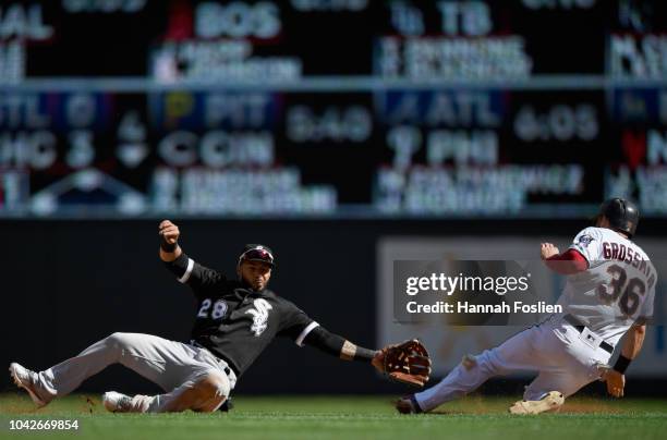 Robbie Grossman of the Minnesota Twins reaches second base on a wild pitch as the ball gets away from Leury Garcia of the Chicago White Sox during...