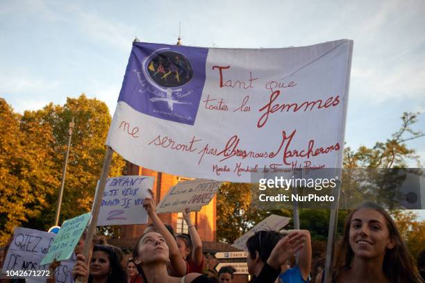Two women hold a banner reading ' As long as women will not be free, we'll walk'. Women and men took to the streets of Toulouse for the International...
