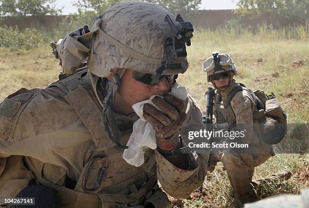 Marines provide cover as Navy Corpsman HN Ikaika McCallum of Kaneohe, HI makes his way to a Medevac helicopter after being shot in the face while on...