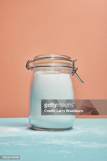sugar in jar and sprinkled over counter - sugar in glass stock pictures, royalty-free photos & images