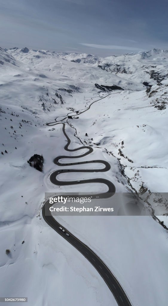 View from above winding road through snow covered mountain, St. Moritz, Switzerland