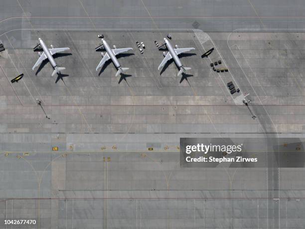 Aerial view airplanes parked on tarmac at airport