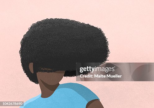 Woman's afro covering face on pink background Woman's afro covering face on pink background